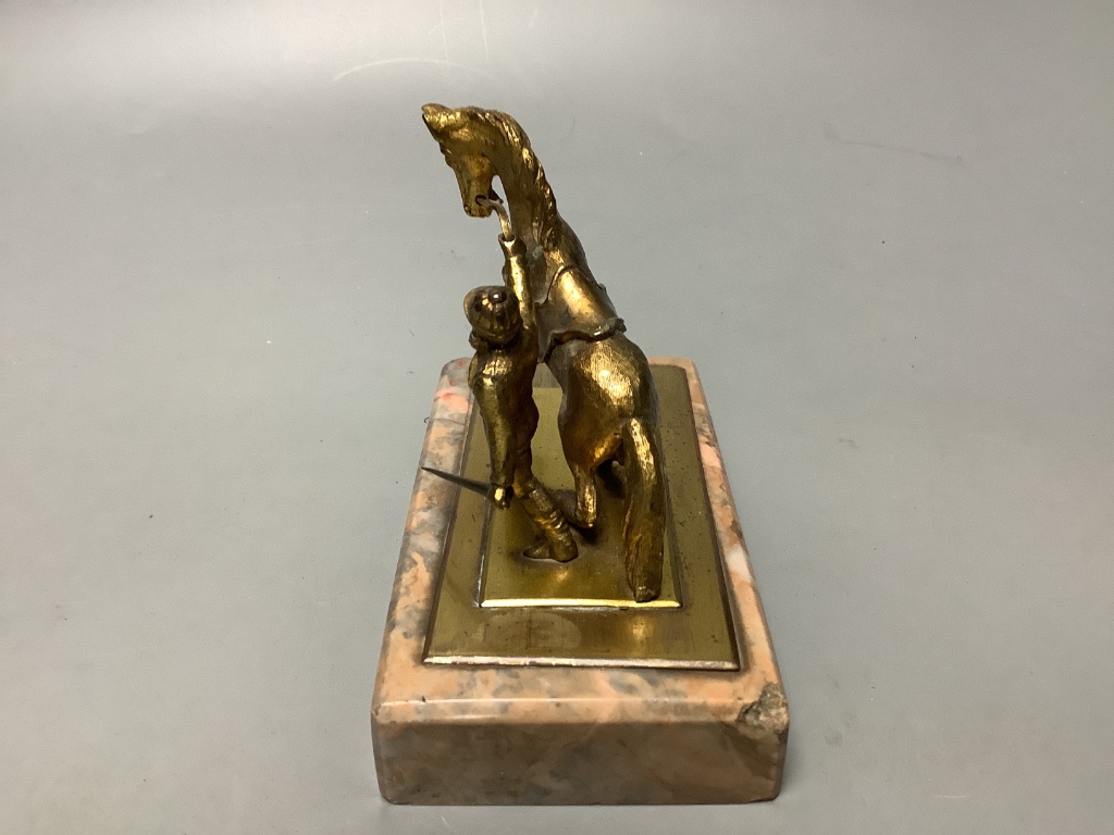 An early 20th century gilt metal group of a horse and jockey, on marble base, length 13cm